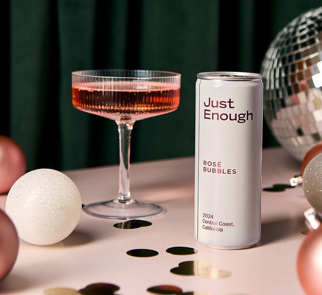 Just Enough Rosé Bubbles canned wine beside a coupe glass of sparkling rosé from California’s Central Coast.
