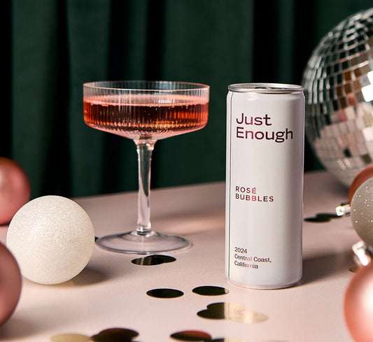 Just Enough Rosé Bubbles canned wine beside a coupe glass of sparkling rosé from California’s Central Coast.