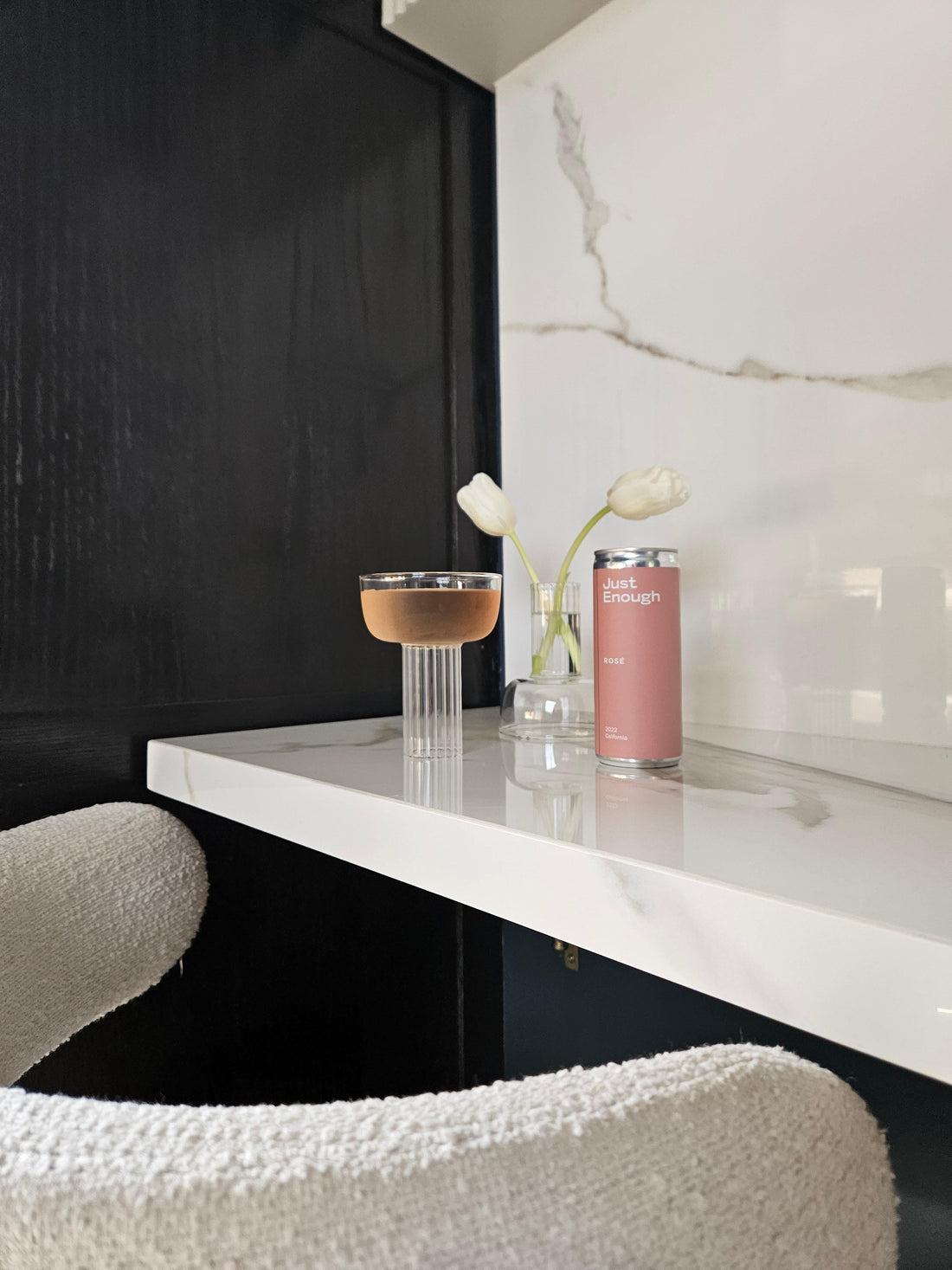 Just Enough Wine’s canned Rosé poured into a glass, showcasing the wine’s color and clarity.
