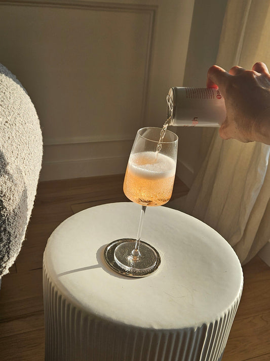 Rosé wine from Just Enough Wines poured into a glass on a sunlit table for a relaxed evening.